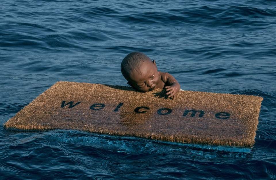 A floating infant clinging to a doormat: this is Federico Clapis' installation for migrants 