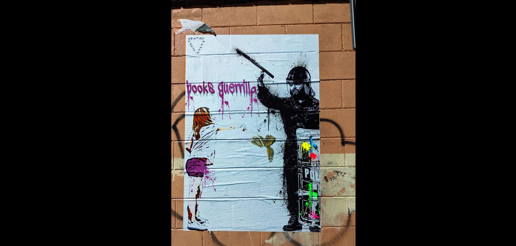 Street art against police officers beating students. The work of Cristina Donati Meyer