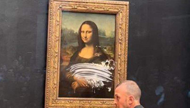 Louvre, visitor throws a cake at the Mona Lisa. No damage to the work
