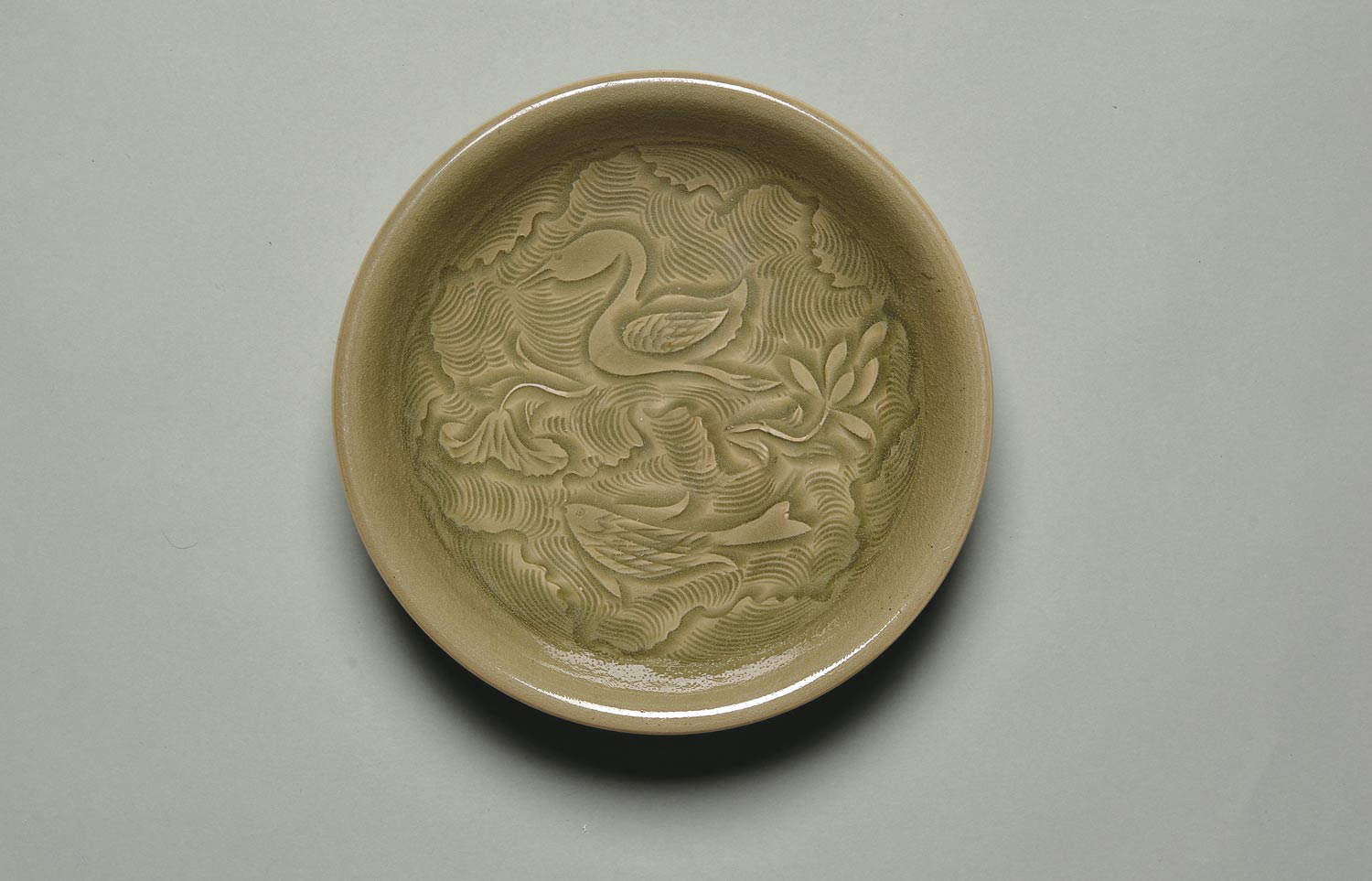 Yaozhou Furnaces, Dish with goose, fish and lotus motif among waves (Northern Song Dynasty - 960-1127; Stoneware with blue-green glaze, diameter 18.3 cm; Shang Shan Tang Collection)