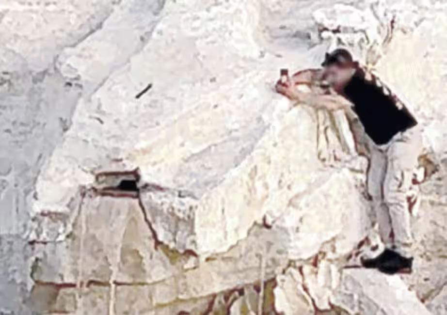 Tourist on the Trevi fountain to take a selfie Tourist on the Trevi fountain to take a selfie