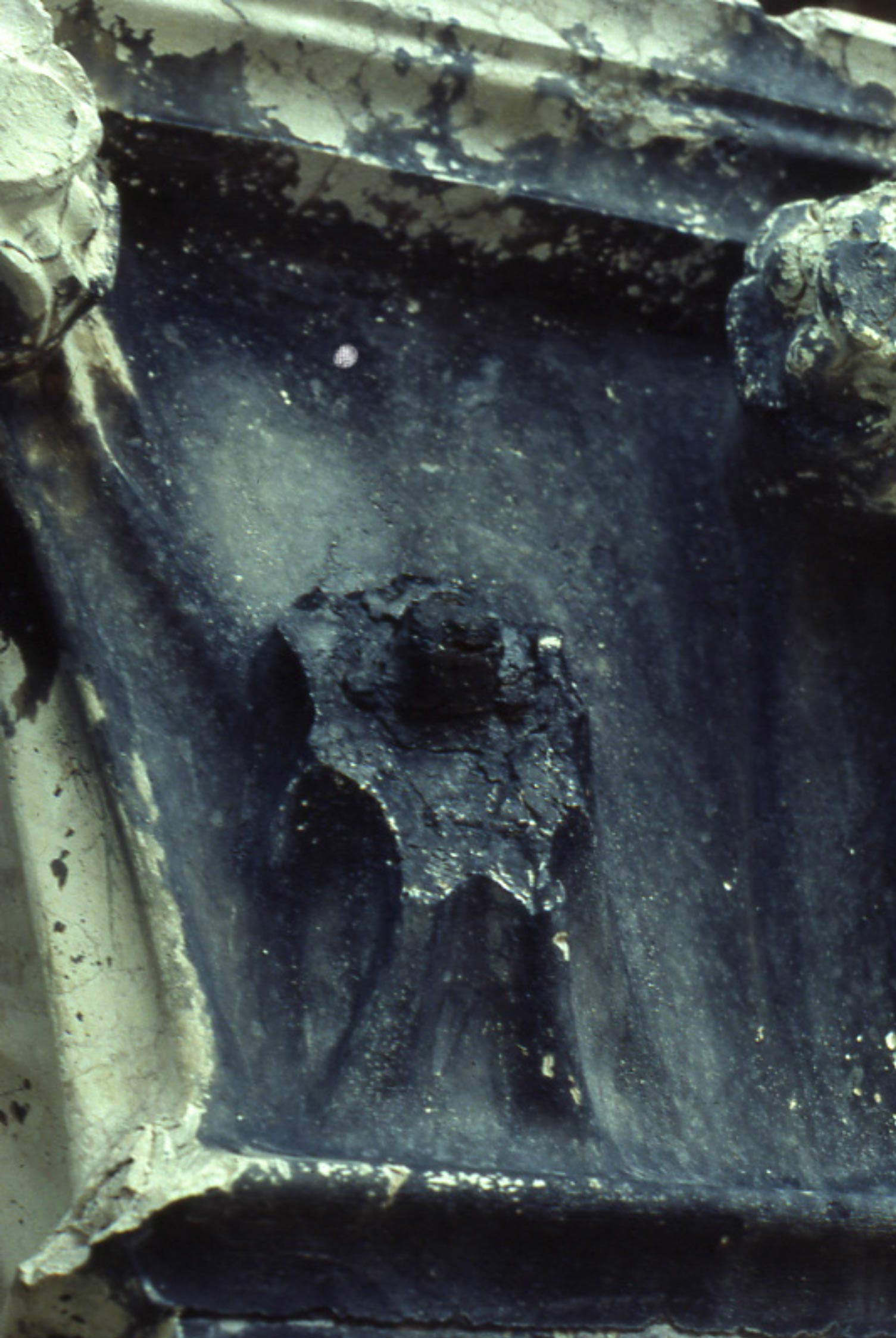 Parma, Metropolitan Baptistery, antelamic devil figure completely covered with a blackish layer of calcium oxalates. Parma, Metropolitan Baptistery, antelamic devil figure completely covered with a blackish layer of calcium oxalates.