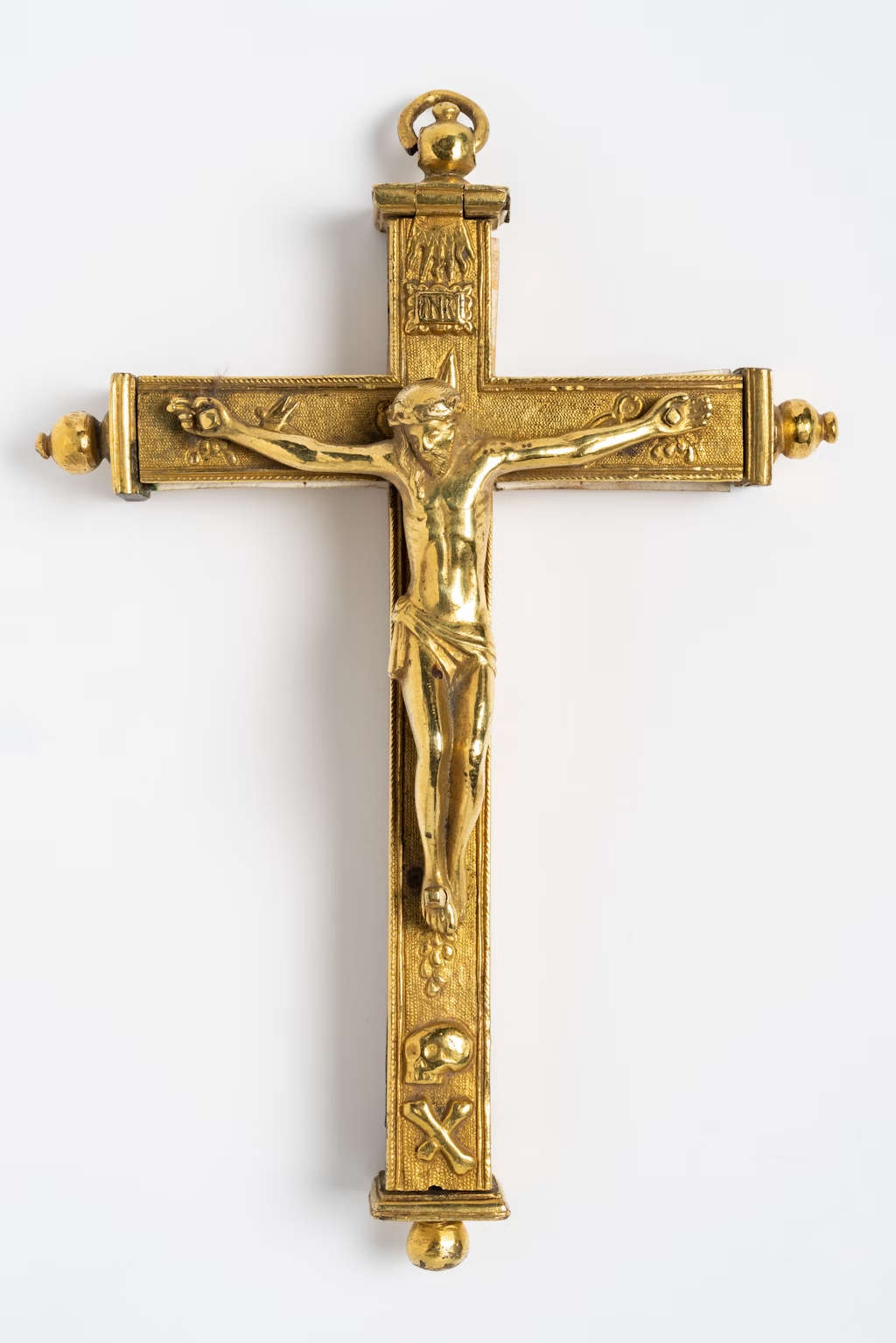 Spanish manufacture, Processional cross (17th century; bronze, paper, bone, wax, 14 x 10 x 2.5 cm).