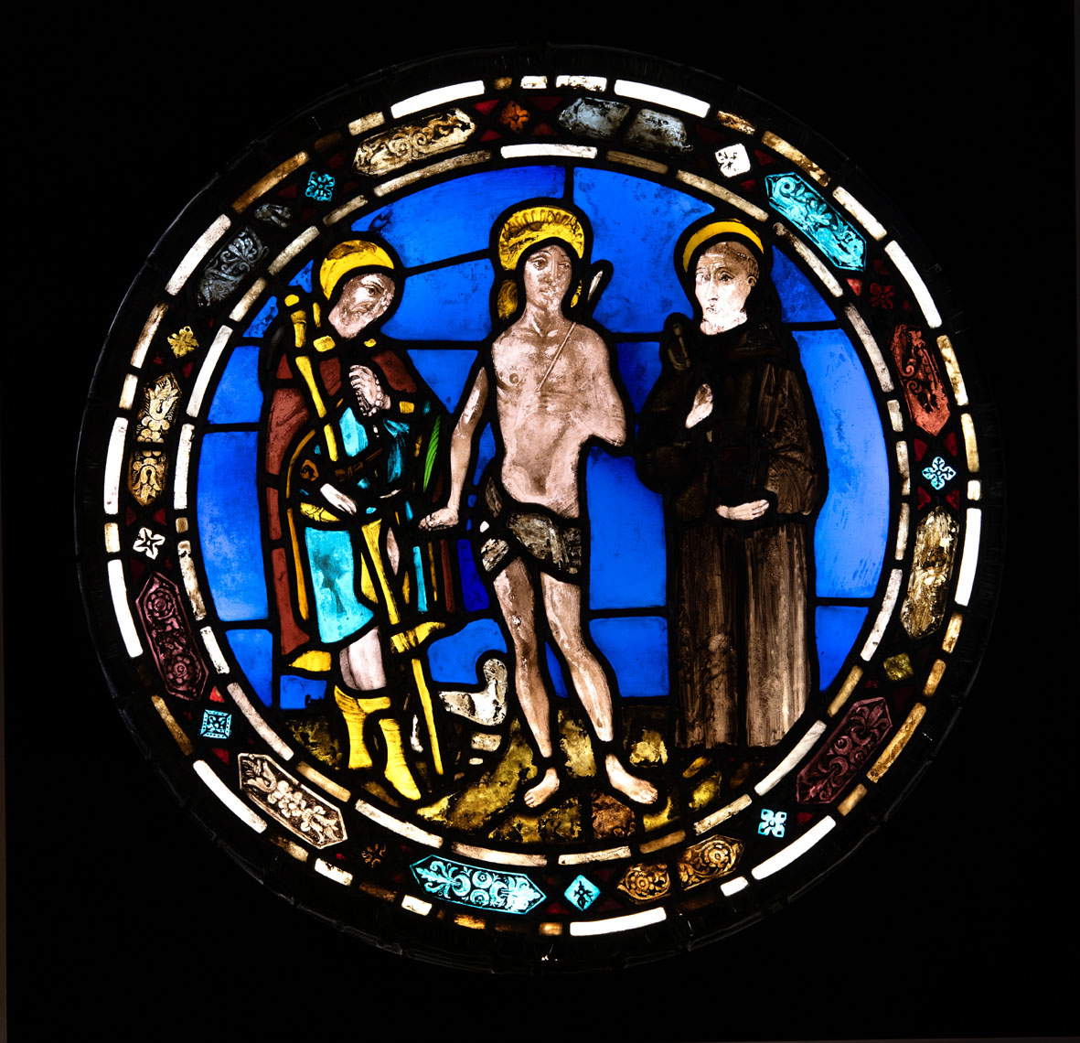 Nastagio di Guasparre, The Saints Roch, Sebastian and Leonard (sixth decade of the 15th century; stained and grisaille-painted glass, assembled with tin-soldered lead profiles; Chiusdino, Museo Civico e Diocesano d'Arte Sacra di San Galgano) Nastagio di Guasparre, The Saints Roch, Sebastian and Leonard (sixth decade of the 15th century; stained and grisaille-painted glass, assembled with tin-soldered lead profiles; Chiusdino, Museo Civico e Diocesano d'Arte Sacra di San Galgano)