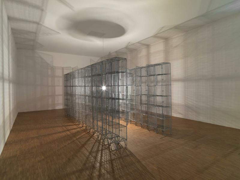 Mona Hatoum, Light sentence (1992; wire mesh, electric motor, timer, bulb, cables, electric wire, dimensions variable; Paris, Centre Pompidou)