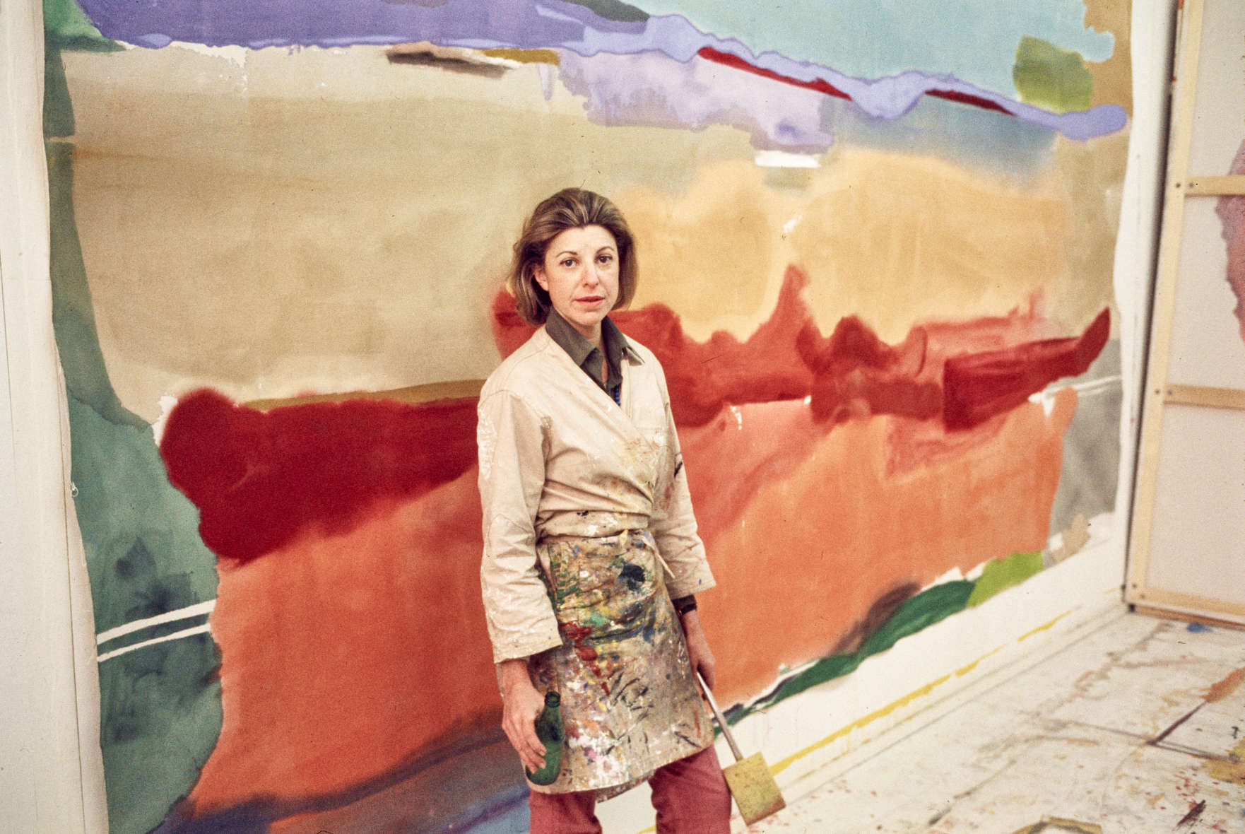 Helen Frankenthaler in her East 83rd Street studio while at work on April Mood and Under April Mood (both 1974), New York, 1974. Photo: Alexander Liberman; © J. Paul Getty Trust. Getty Research Institute, Los Angeles (2000.R.19). Artwork © 2024 Helen Frankenthaler Foundation, Inc./ Artists Rights Society (ARS), New York. Helen Frankenthaler in her East 83rd Street studio while at work on April Mood and Under April Mood (both 1974), New York, 1974. Photo: Alexander Liberman; © J. Paul Getty Trust. Getty Research Institute, Los Angeles (2000.R.19). Artwork © 2024 Helen Frankenthaler Foundation, Inc./ Artists Rights Society (ARS), New York.