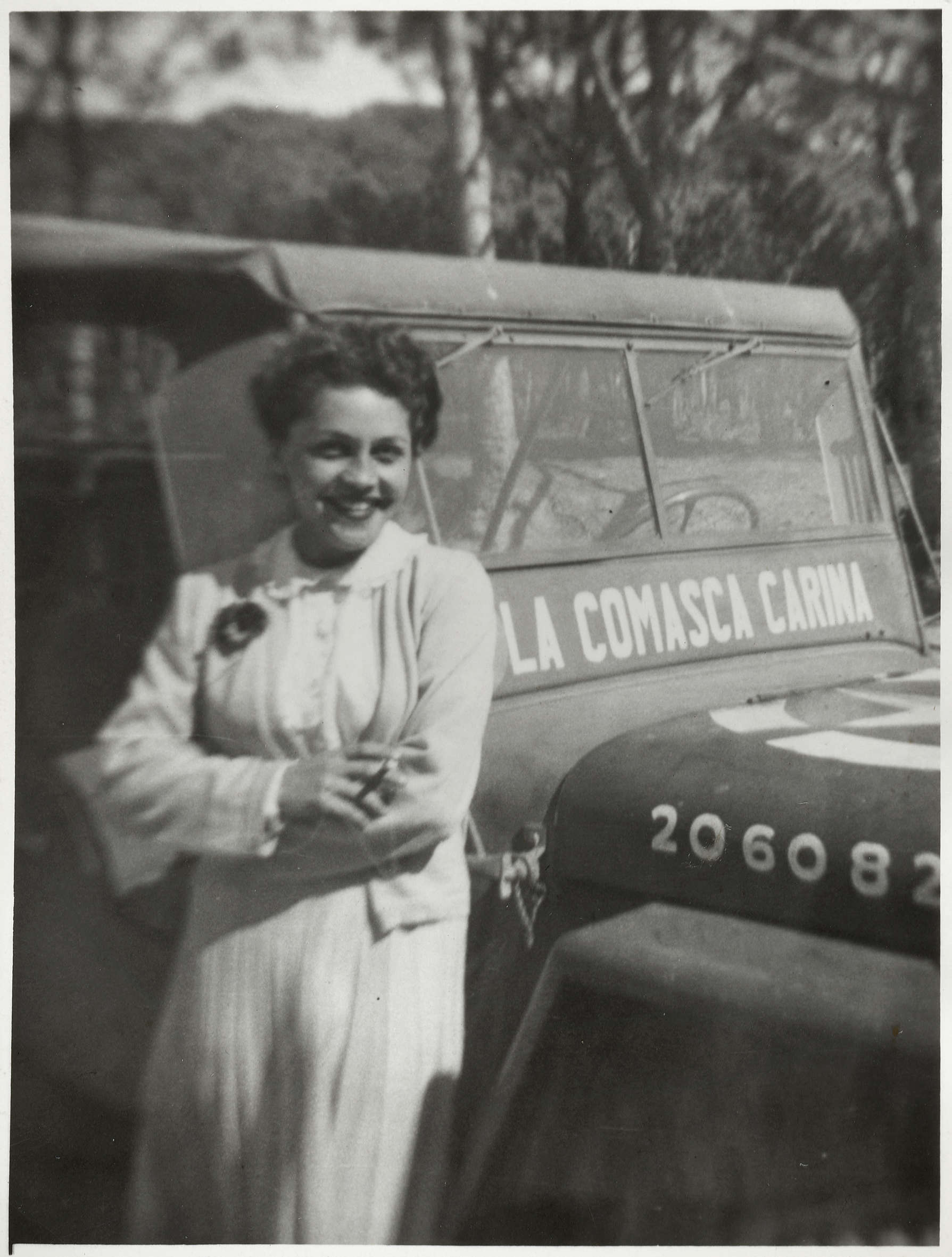 Luisa Albertini, fotografiert am Militärjeep der Alliierten mit der Aufschrift 