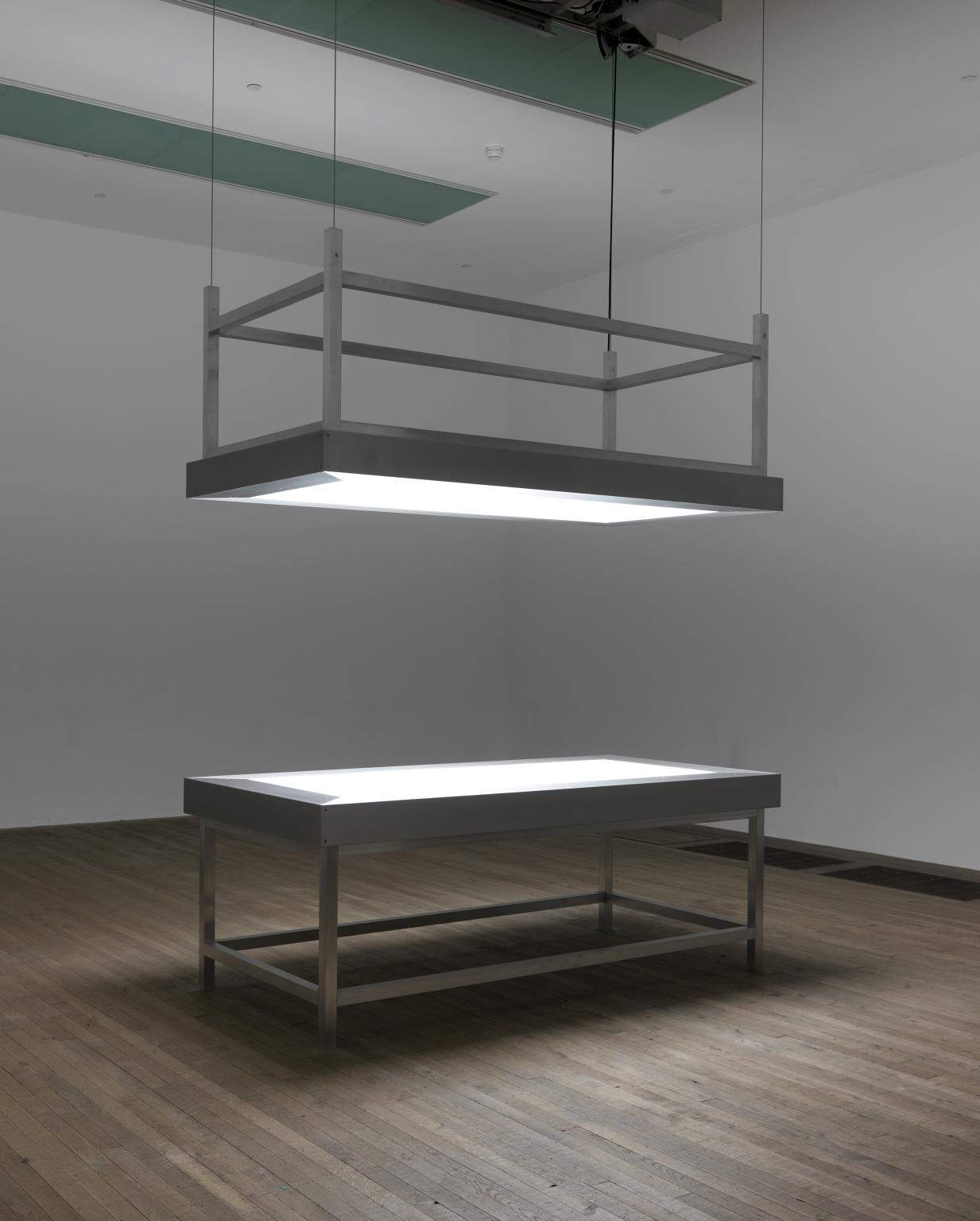 Alfredo Jaar, Lament of the images (2002; two aluminum tables, Plexiglas, LED lights and motorized lifting mechanism; London, Tate Modern)