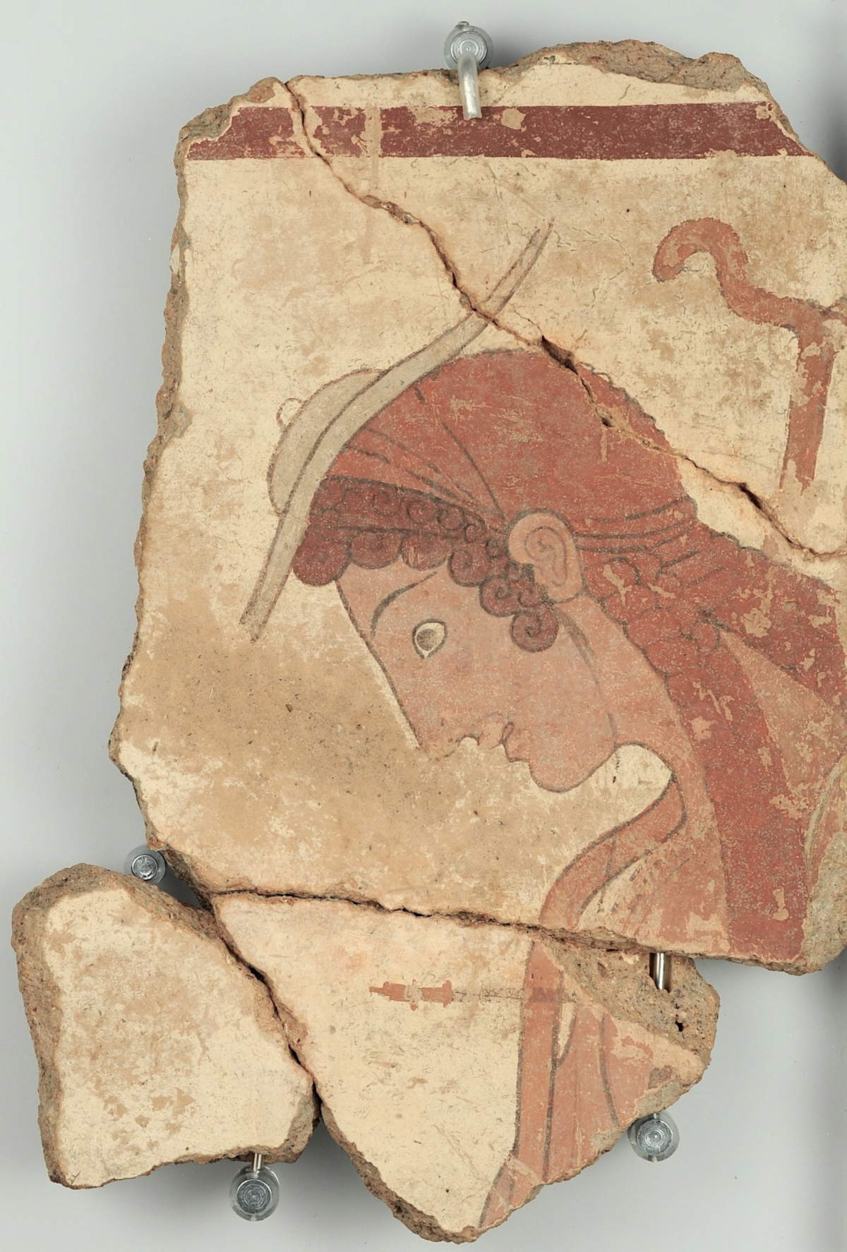 Frammento di lastra di terracotta dipinta con giovane in abiti da viaggio (ca. 500 a.C.) temporaneamente esposta al Museo Archeologico Nazionale di Firenze.