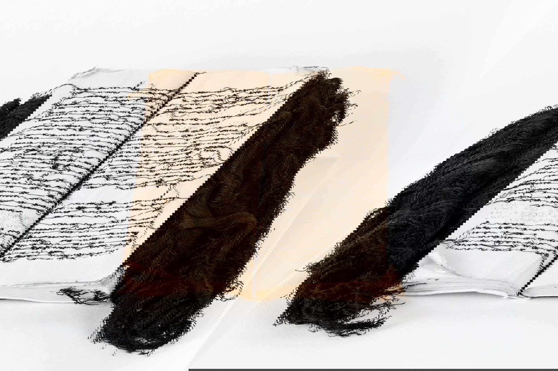 Maria-Lai, Book-scalp (1990; book, cotton threads, 29 x 30 cm; Art Station Foundation Collection). @Art Station