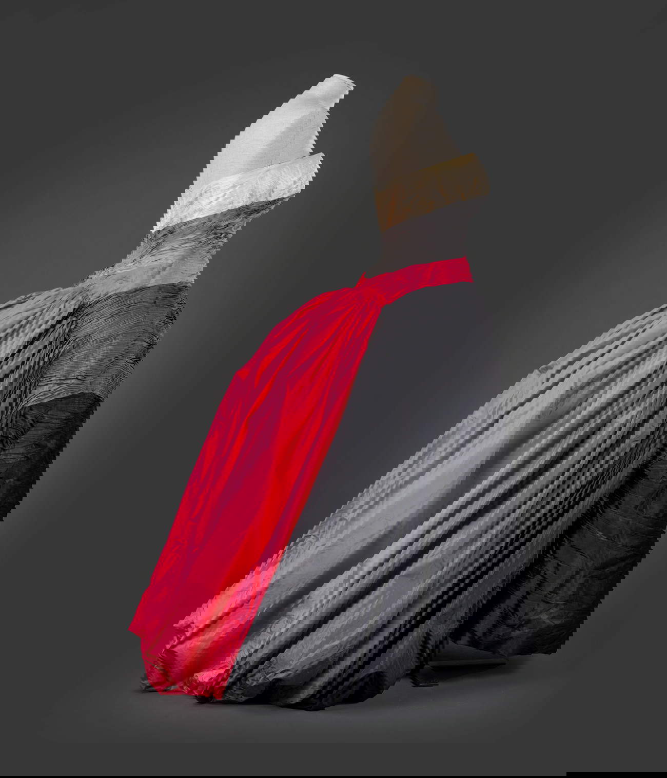 Emilio Federico Schubert, women's dress (c. 1955). Grand evening gown in ivory, light gray, fuchsia, dark gray, and black pleated silk tafettas. Sweetheart neckline with fully splinted bodice, free pleats from hip forming train with each color of taffeta. Underskirts in black and red horsehair. Gift of Gaia Pace. Belonged to Loretta De Angelis Pace. Massimo Cantini Parrini Collection, Florence