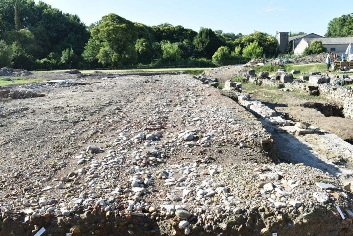 The cobblestone road identified between two of the buildings in the shopping complex