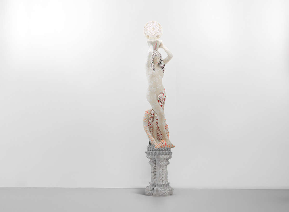 Joana Vasconcelos, Bond Girl (2014; concrete statue, acrylic paint, handmade cotton crochet, plastic globe, light bulb, electrical wiring, 276 &times; 40 &times; 40 cm; Collection of the artist)