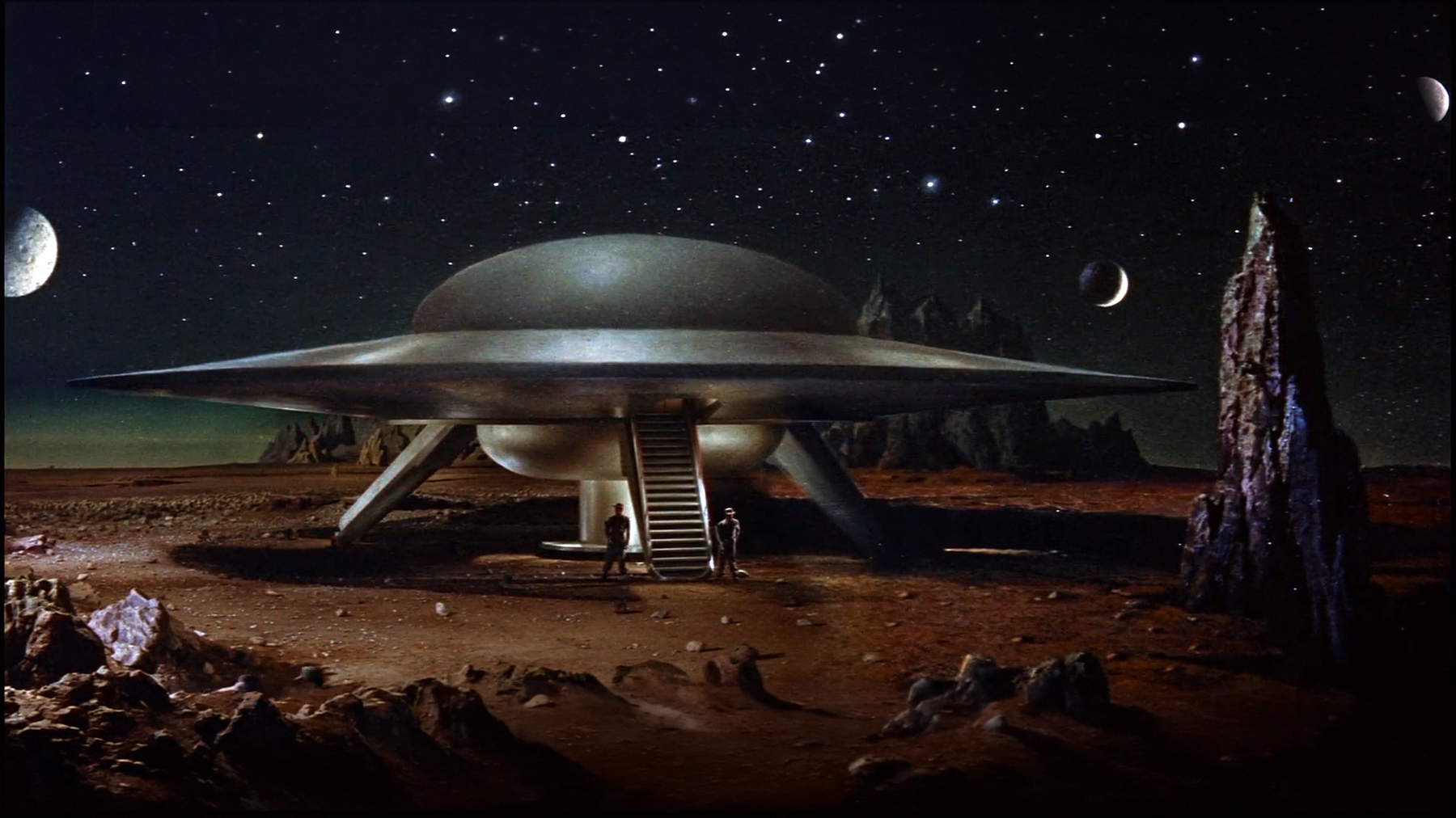 Grafische Darstellung der Ausstellung, inspiriert von der angelsächsischen Fernsehserie UFO (1970-71 - ENG) von Gerry und Sylvia Anderson.