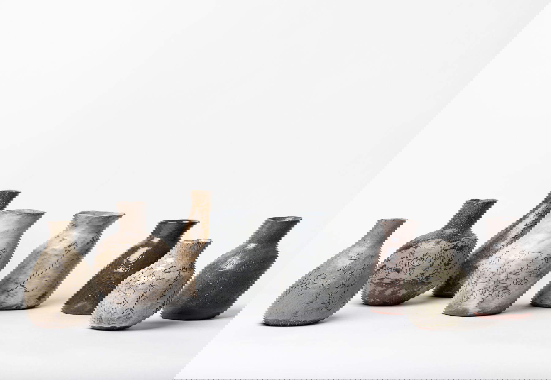 Katia Bagnoli and Bruno Riva, 8 vases and bottles with engraved poems by Rengetsu (2026; pottery with engravings). Photo: Tomoyuki Tsuruta