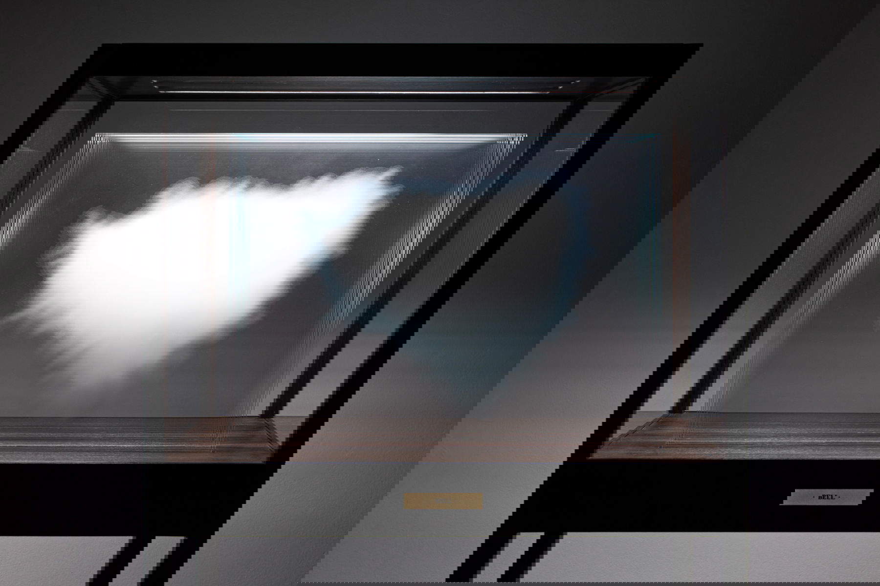 Leandro Erlich, The Cloud - Bell (2024; digital ceramic ink printed on ultra-clear glass, wooden case and LED lights, 175 x 91 x 50 cm) Photo: Duccio Benvenuti - Art Store. Courtesy of Galleria Continua