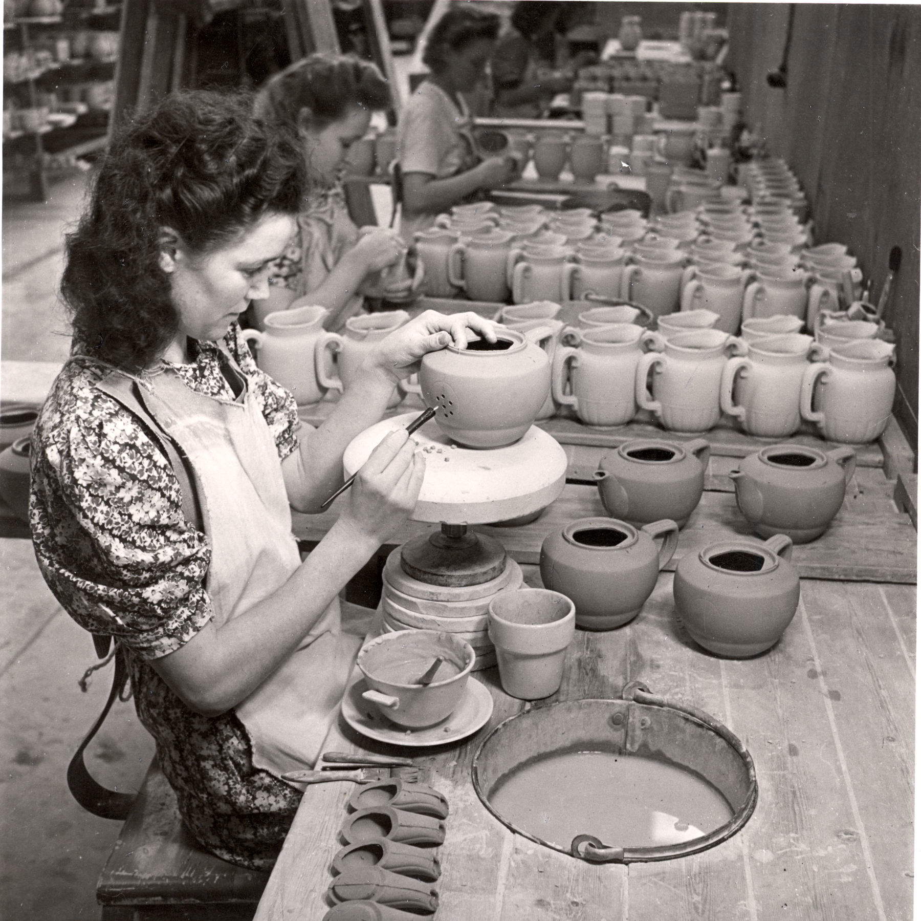 Female workers during various stages of production: glazing, quality control, and packaging of pieces, at the R&ouml;rstrand factory in Sweden.